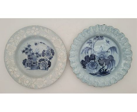 Two mid 18th century English Delftware plates, both with blue ground and with rim painted bianco-sopra-bianco and blue painte