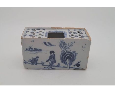 A mid 18th century Bristol Delftware flower brick, painted in blue, length 14.2cm.Condition note: chips and loss of glaze to 