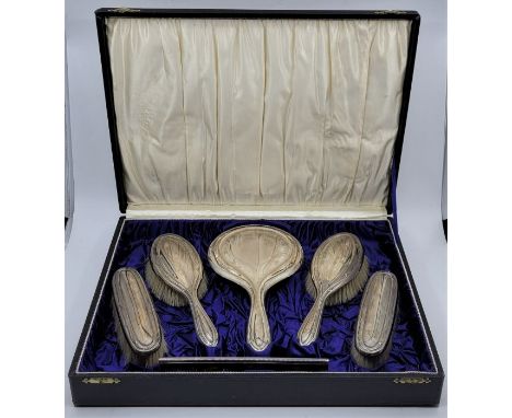 A cased silver six piece dressing table set, by Daniel Manufacturing Company, Birmingham 1928, comprising bevel plated hand m