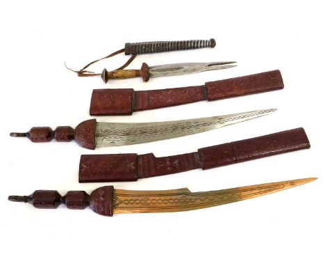 A Late 20th Century Tuareg Takouba Short Sword, the 36cm single edge curved and tapering steel blade incised with elliptical 