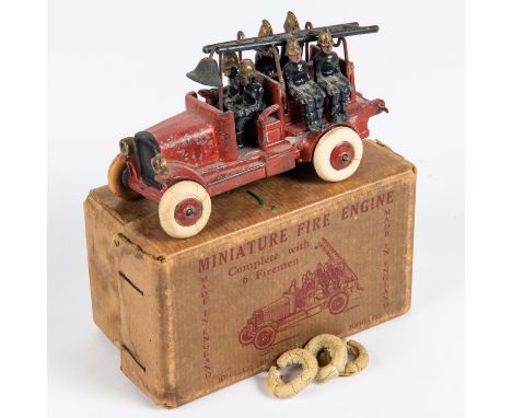 A Johillco Miniature Fire Engine. A red painted fire engine with bell, ladder and complete with 6 firemen. Fitted with white 