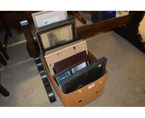 A box containing various pictures and prints 
