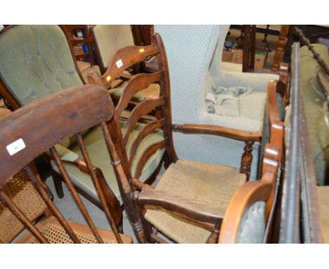 An oak ladder back and string seated elbow chair 
