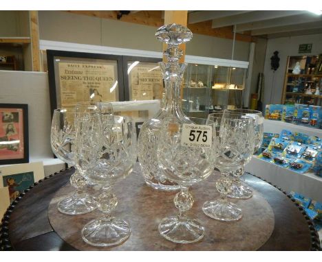 A good quality cut glass decanter and six cut glass wine goblets.