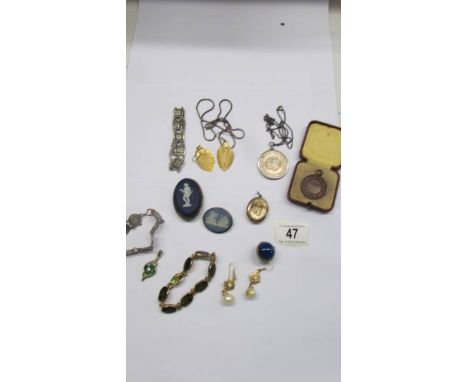 A mixed lot of jewellery including Wedgwood brooches, silver 3d bit bracelet, pendants etc.,