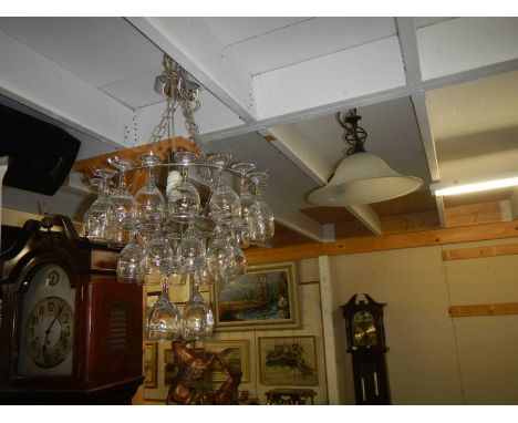 A wine glass chandelier and a misted glass ceiling light.