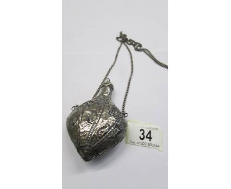 A white metal (possibly silver) embossed snuff box on chain.
