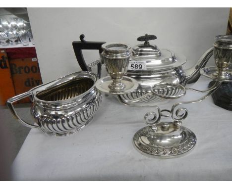 A silver plate teapot, sugar bowl and candelabra.