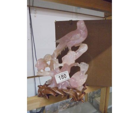 A boxed pink stone carving featuring birds (a/f some chips).Height 18.5cm not including wooden base.
