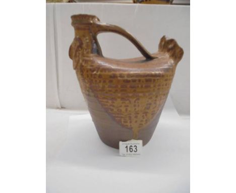 An early 20th century stoneware wine carafe in the form of a chicken.