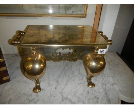 A Victorian brass footman.Wobbles on flat surface, no damage. Height 25cm, Top is 47 x 27cm Wine handles 51cm