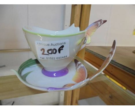 A Franz porcelain tea cup and saucer featuring butterflies.