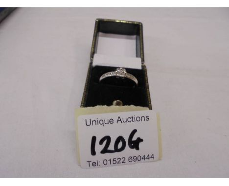 A diamond cluster ring, diamond shoulders set in white gold (ideal engagement ring), size O, 2.51 grams.
