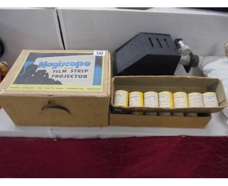 A boxed vintage Magiscope 35mm film strip projector with films.