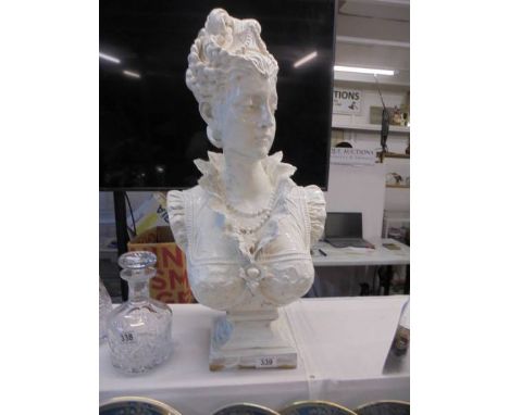 A large painted ceramic female bust.