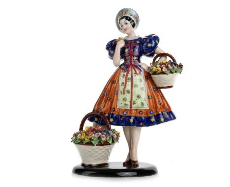 IN THE MANNER OF LENCI, AN ITALIAN PORCELAIN FIGURE modelled as a lady with baskets of flowers and with an oval stand, marked