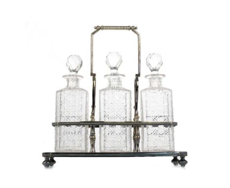 SILVER PLATED THREE PIECE TANTALUS, fitted with three cut glass decanters and stopperstantalus 36cm wideThere is an element o