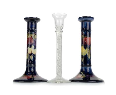 MATCHED PAIR OF MOORCROFT CANDLESTICKS, ALONG WITH AN AIRTWIST CANDLESTICK each of cylindrical form, to spreading circular ba
