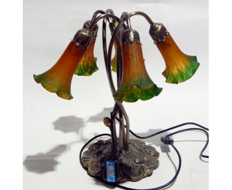 A Tiffany style lamp on intertwined necks, on a floral decorated base 