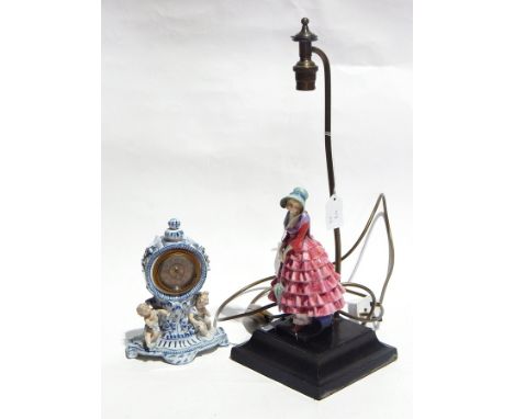Continental porcelain cased mantel time-piece, blue and white with putti, 20cms high and table lamp, the wooden base surmount
