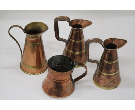 FOUR VINTAGE BRASS AND COPPER JUGS 