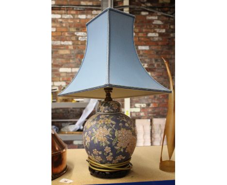 AN ORIENTAL LAMP BASE WITH BLUE SHADE 