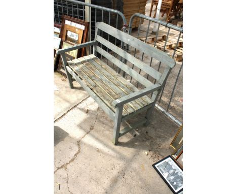 A TWO SEATER WOODEN SLATTED GARDEN BENCH 