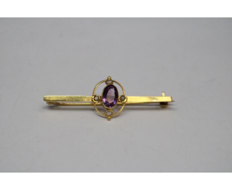 A VINTAGE 9 CARAT GOLD PIN BROOCH WITH CENTRE AMETHYST AND FOUR SEED PEARLS GROSS WEIGHT 1.89 GRAMS 