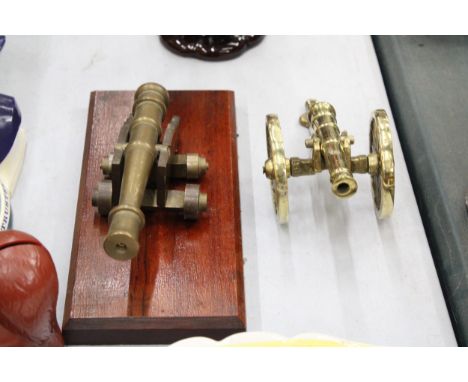A VINTAGE BRASS CANON ON A WOODEN PLINTH PLUS ONE OTHER 