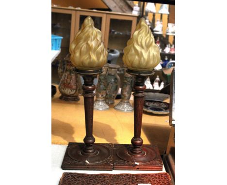A PAIR OF WOOD AND COPPER LAMP BASES WITH FLAME SHADES 