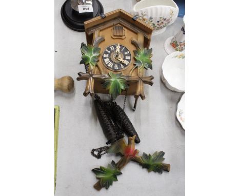 A WOODEN CUCKOO CLOCK WITH WEIGHTS 