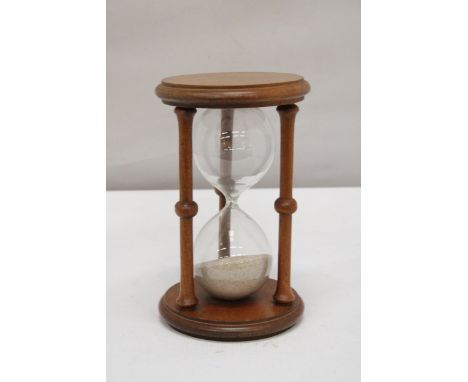 A LARGE WOODEN GLASS EGG TIMER 