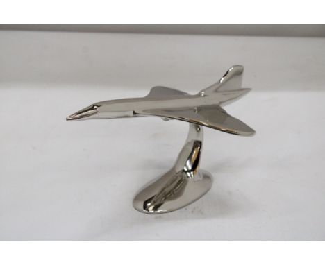 A LARGE CHROME MODEL OF CONCORDE ON A STAND, HEIGHT 16CM, LENGTH 29CM 