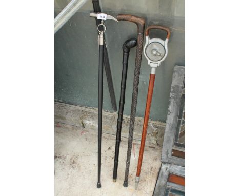 THREE VARIOUS DECORATIVE WALKING STICKS AND A SHOOTING STICK 