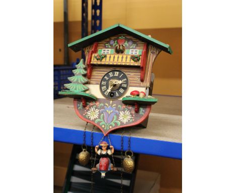 A SMALL WOODEN CUCKOO CLOCK 