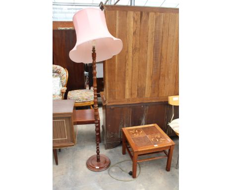 A STANDARD LAMP ON TURNED COLUMN WITH SHADE 