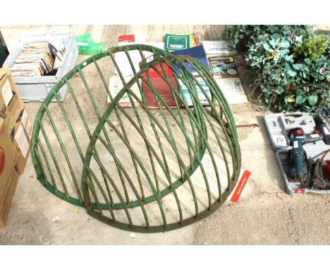 TWO LARGE VINTAGE GREEN PAINTED METAL HAY CRUTCHES 