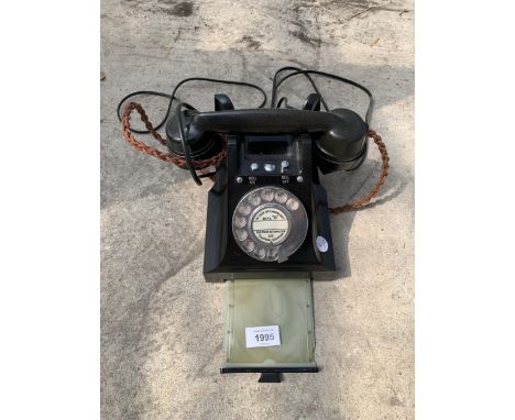 A VINTAGE BLACK ROTARY DIAL TELEPHONE 