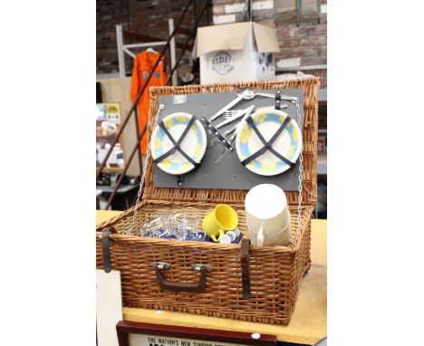 A VINTAGE WICKER 'ANTLER' PICNIC BASKET, WITH A THERMOS FLASK, 'TUPPERWARE' BOXES, GLASSES, PLATES, CUPS, CUTLERY, ETC 
