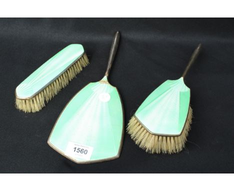 A HALLMARKED SILVER AND ENAMEL DRESSING TABLE SET COMPRISING OF TWO BRUSHES AND A MIRROR 