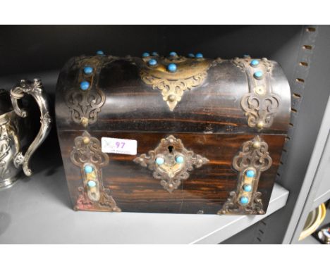 A mid Victorian dome topped chest tea caddy having brass banding and azure blue cabochon decoration. Hinge needs repairing an