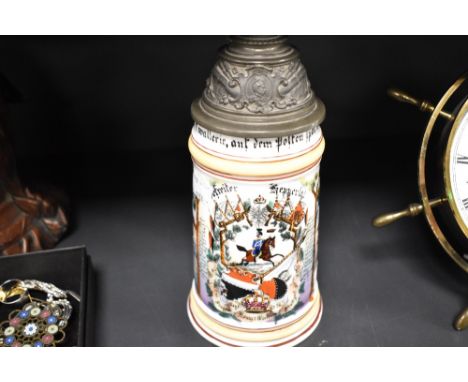 A German porcelain tankard with pewter mounted lid marked Ladan Darmstadt with enamel decoration over transfer design with mi