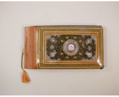 India, a lacquer bookcover, 20th century decorated with painted patterns and center motif of palaces and figures. (small dama