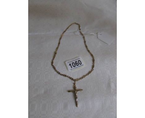 A 9ct gold crucifix on a 9ct gold chain, 13 gms