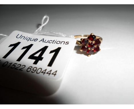 A 9ct gold ring set garnet cluster, size K