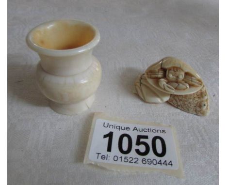 An ivory netsuke of a crab and a small pot