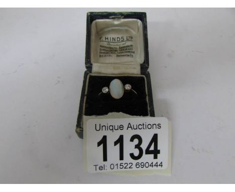 An 18ct gold ring set opal and 2 diamond shoulders