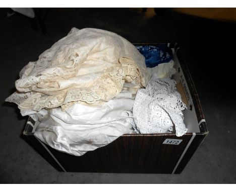 A box of vintage lace including wedding dress