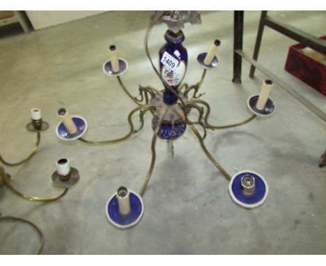 A 6 lamp brass and ceramic ceiling light