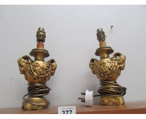 A pair of table lamp bases featuring rams heads